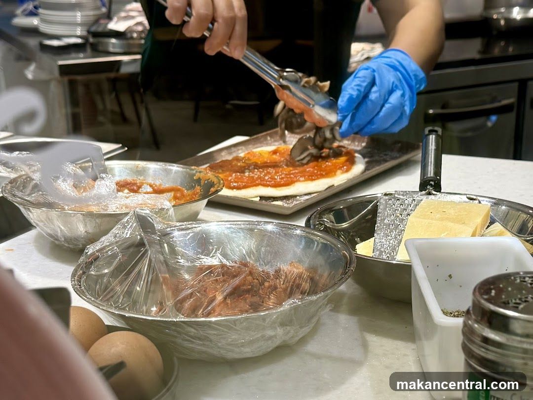 Pizza preparation in kitchen