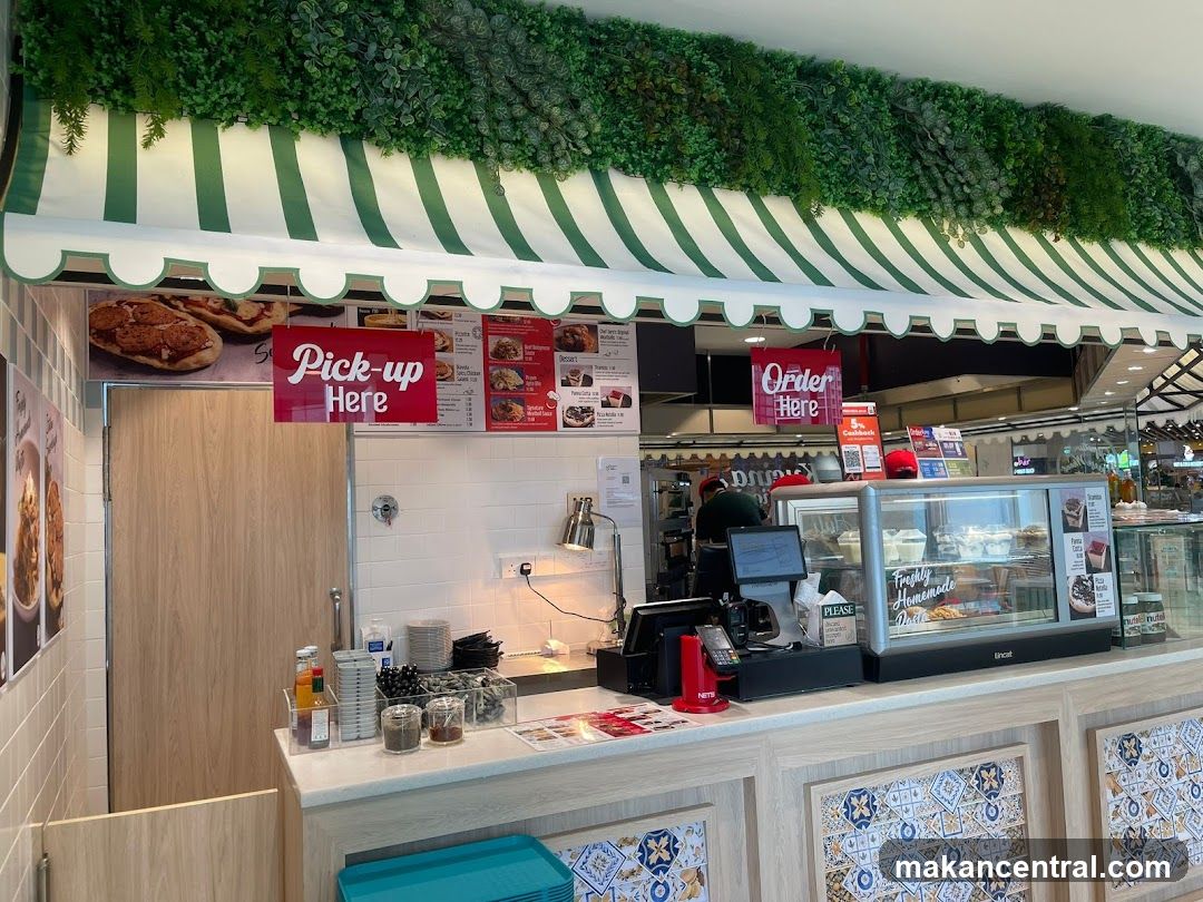 Food stall interior with pick-up and order signs