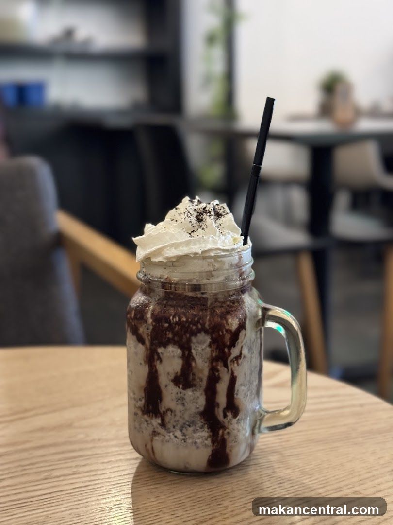 Milkshake in mason jar with whipped cream and straw
