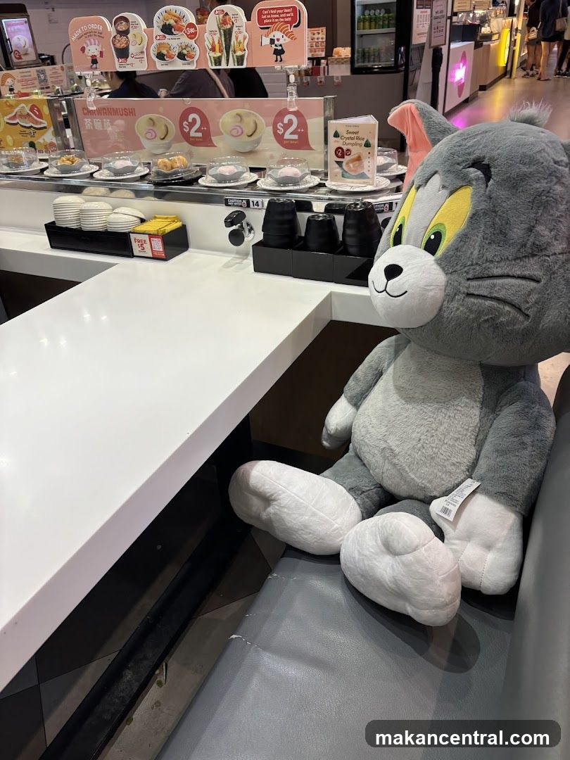 Tom & Jerry plush toy at sushi restaurant counter