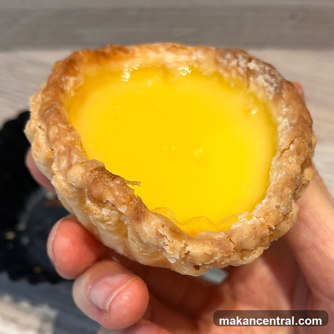 Hand Holding Egg Tart