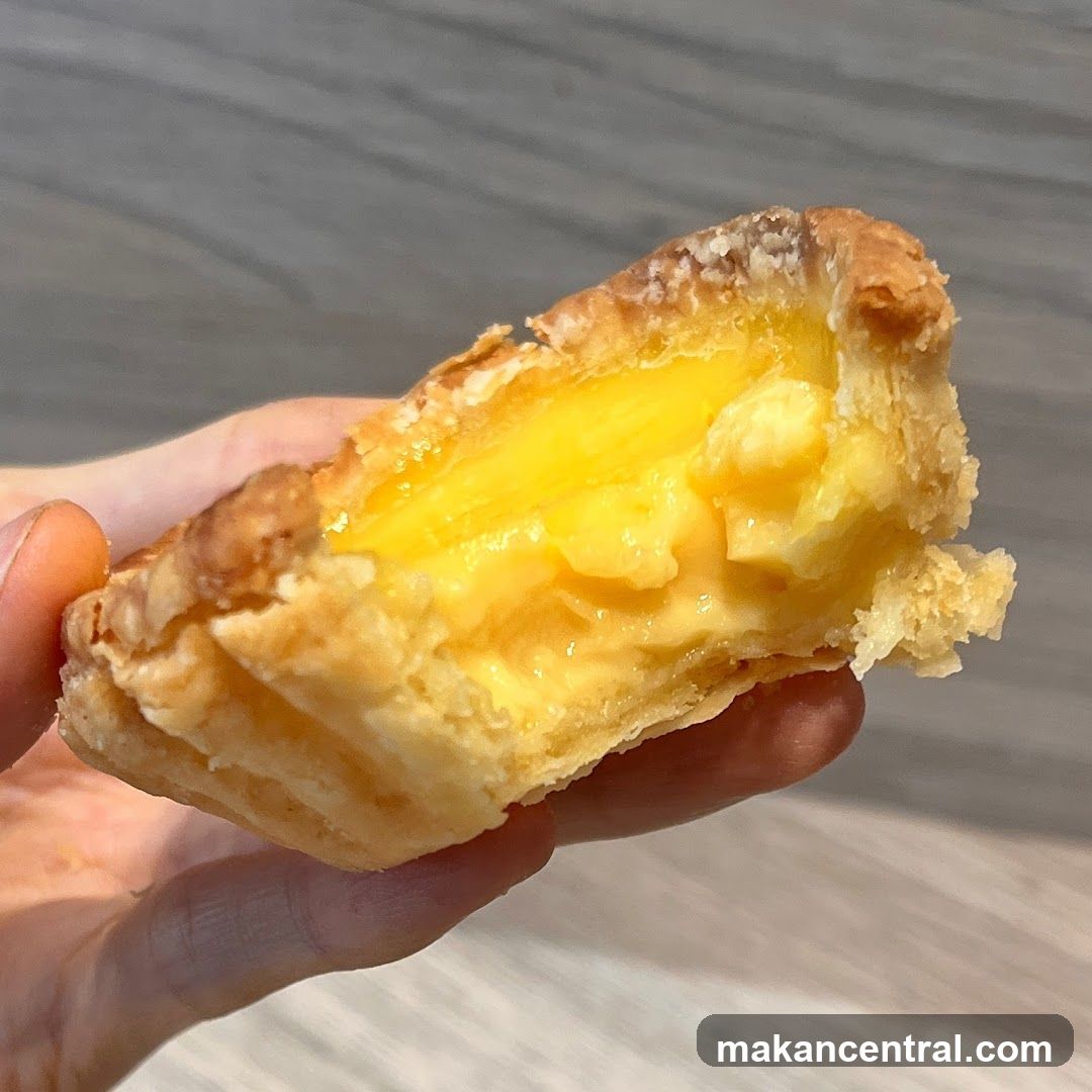 Hand holding a partially eaten pastry