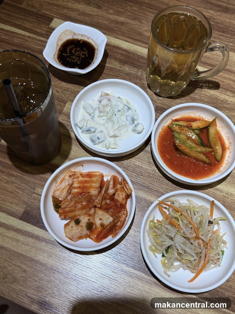 Table with Korean side dishes and drinks
