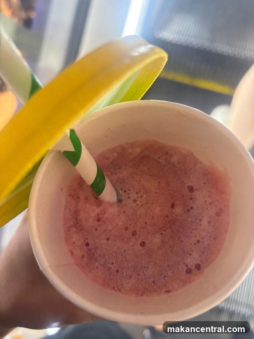 Smoothie in cup with straw and lid