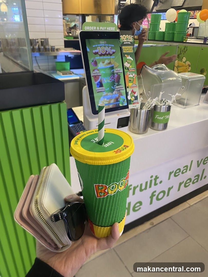 Customer holding beverage at counter