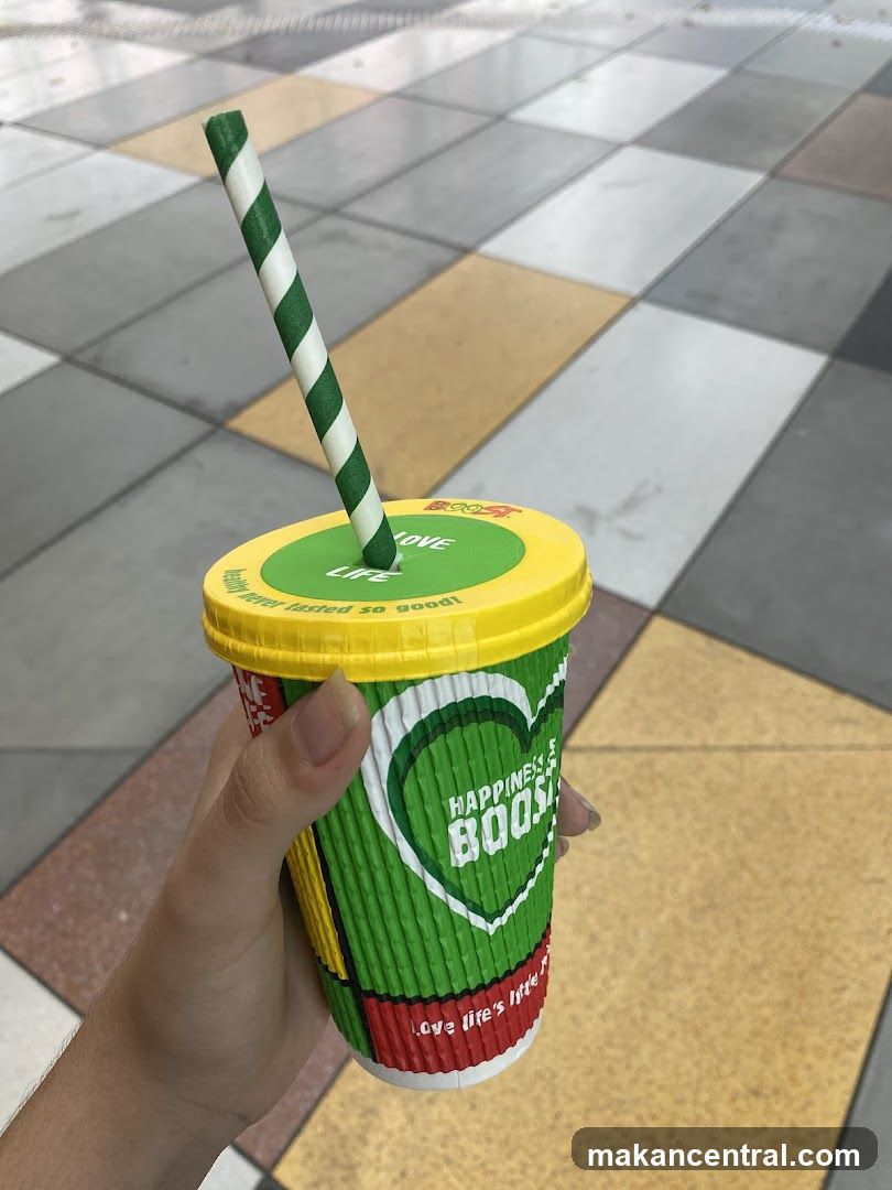 Hand holding beverage cup