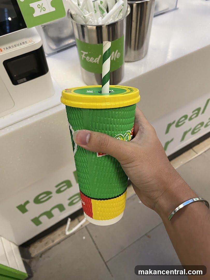Hand holding drink cup at counter
