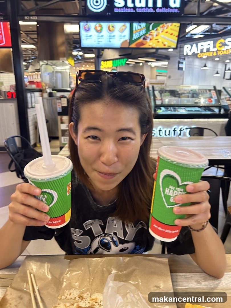 Person holding drinks at food court