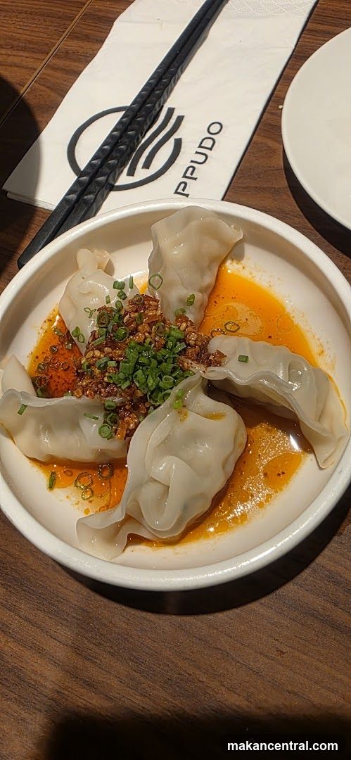 Dumplings with chili oil and garnish