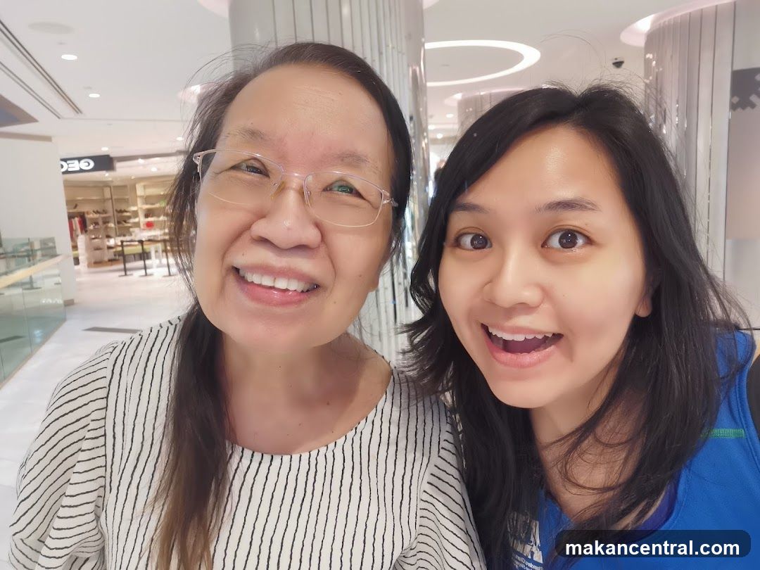 Two individuals in a shopping mall interior
