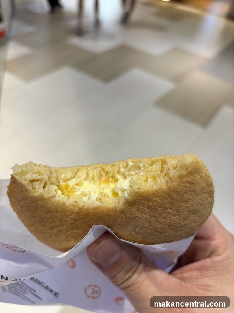 Hand holding a partially eaten pancake