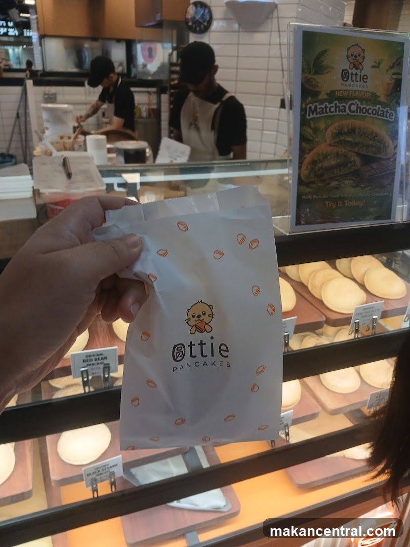 Customer holding branded packaging at pancake shop