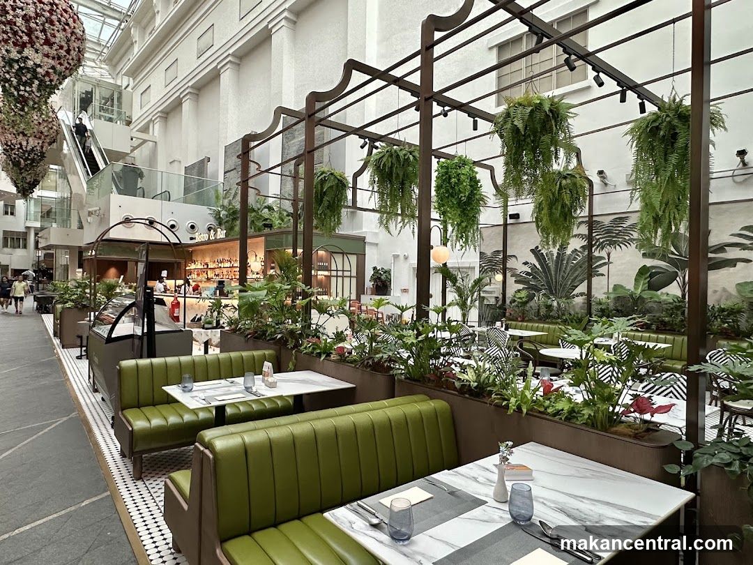 Indoor dining area with greenery and seating