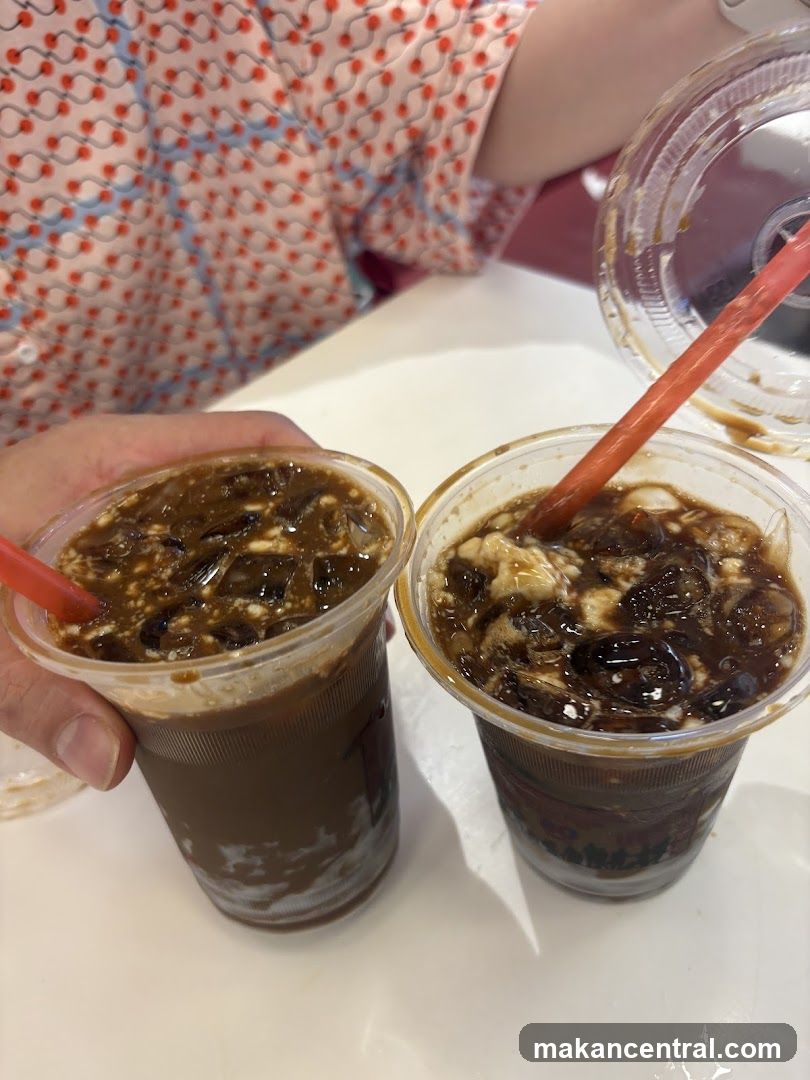 Two iced beverages with straws