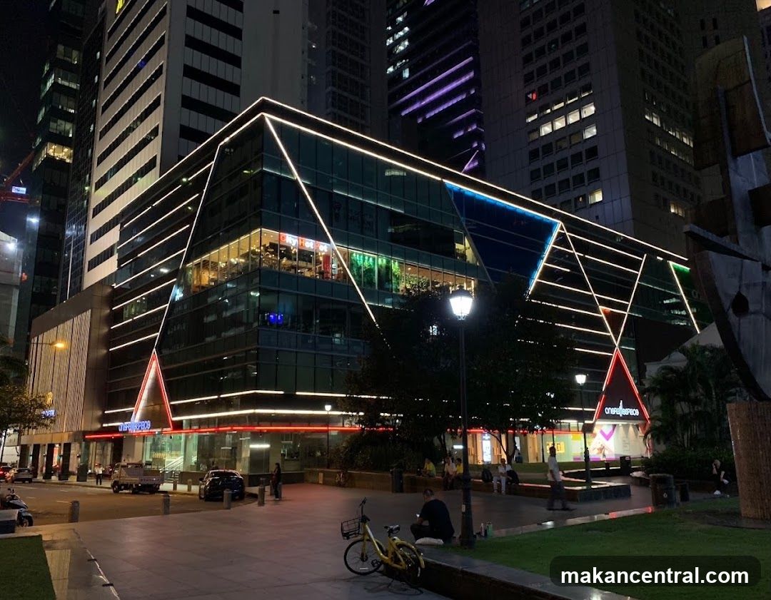 Nighttime urban plaza with illuminated building facade
