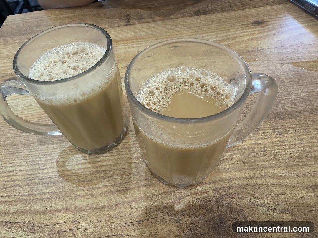Two mugs of tea on wooden table