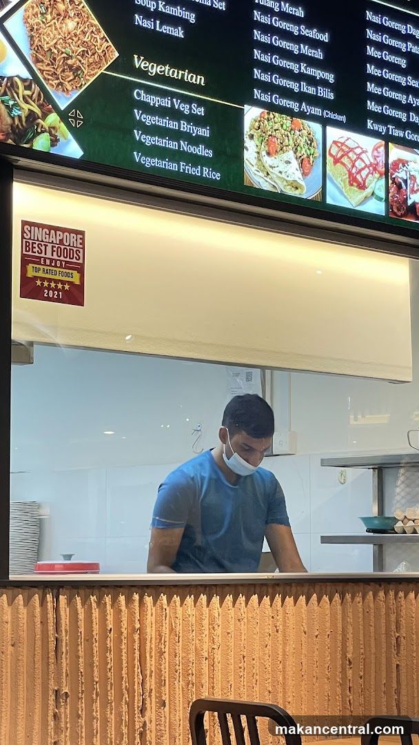 Food stall interior with staff and menu board