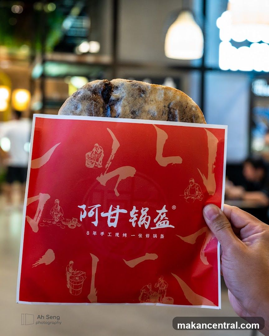 Hand holding branded packaging with food