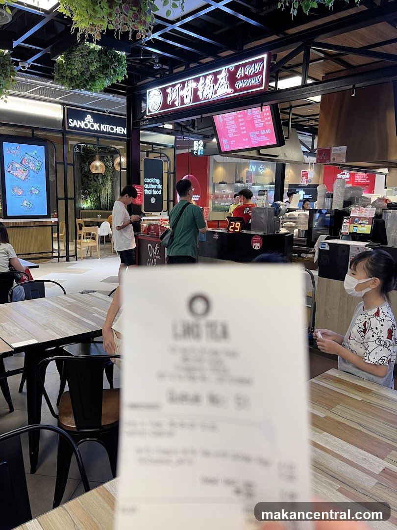 Food court interior with customers and signage