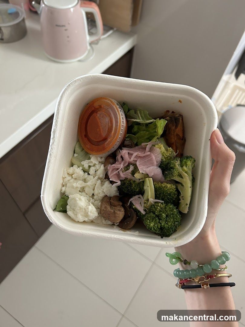 Hand holding meal container
