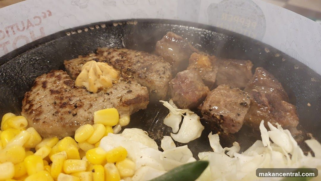 Grilled meat and vegetables on a hot plate