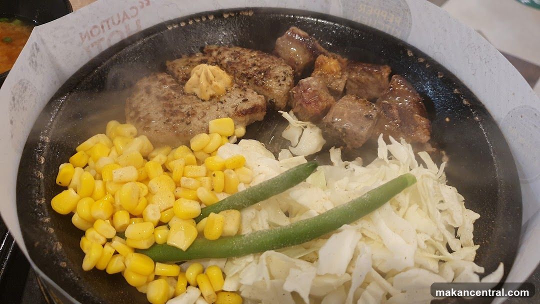 Grilled meat and vegetables on a hot plate