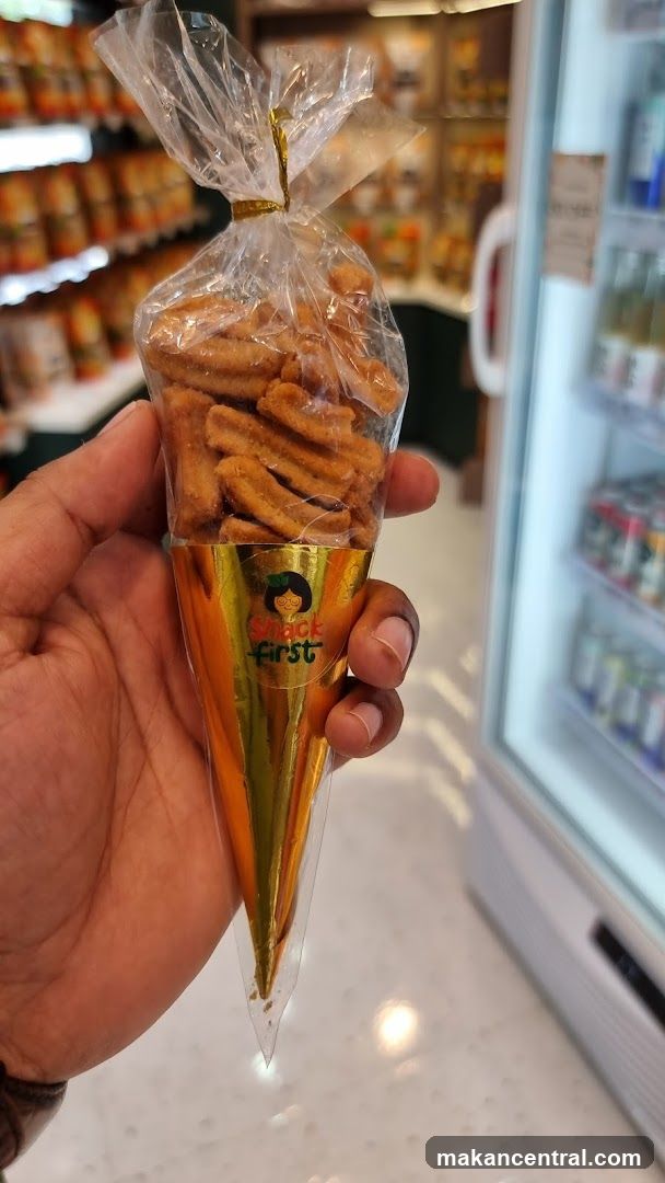 Hand holding snack cone in store