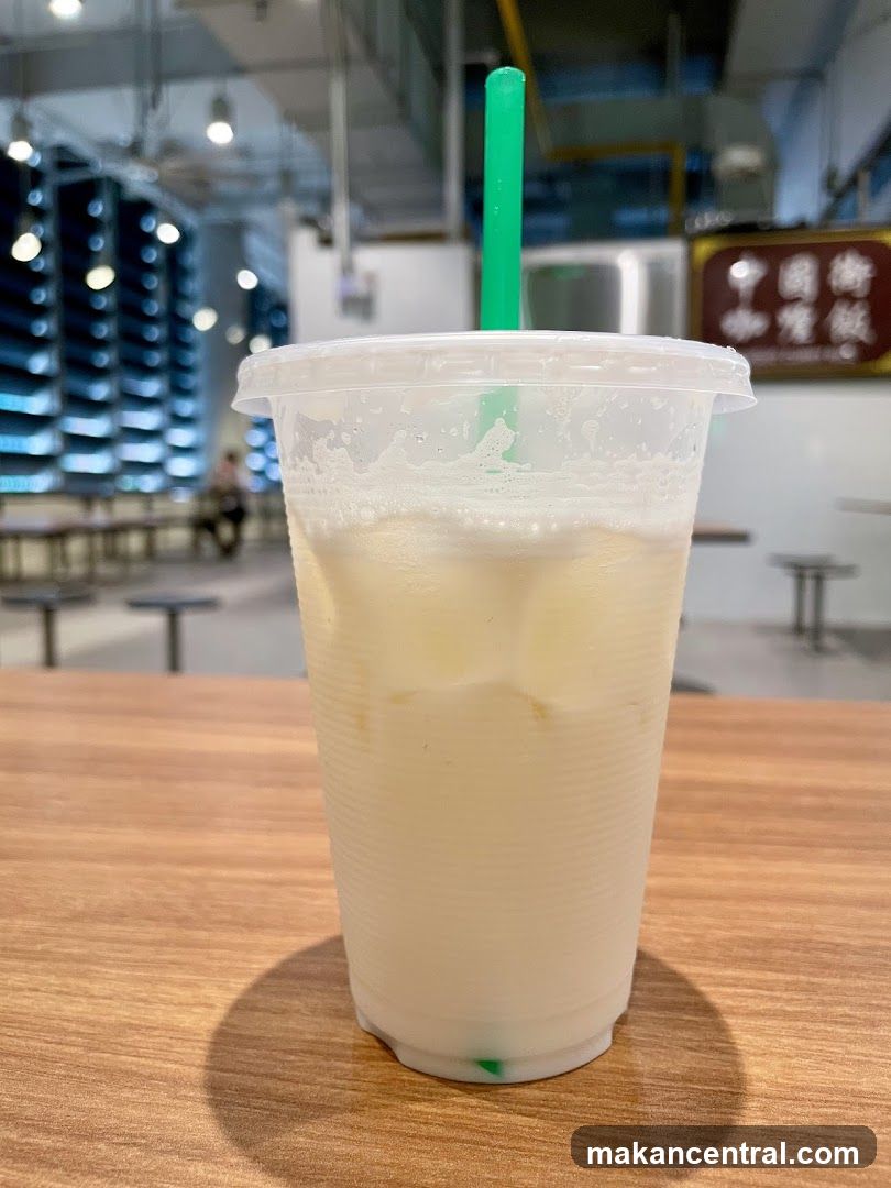 Iced beverage in plastic cup with green straw