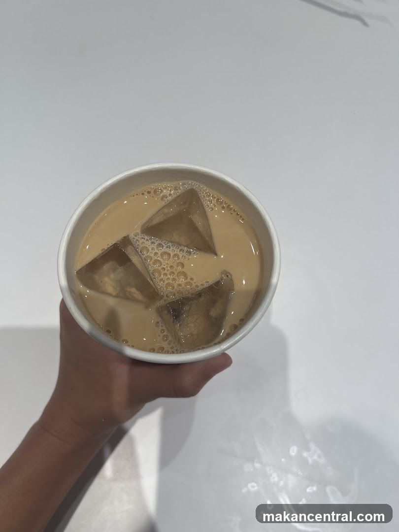 Hand holding iced beverage