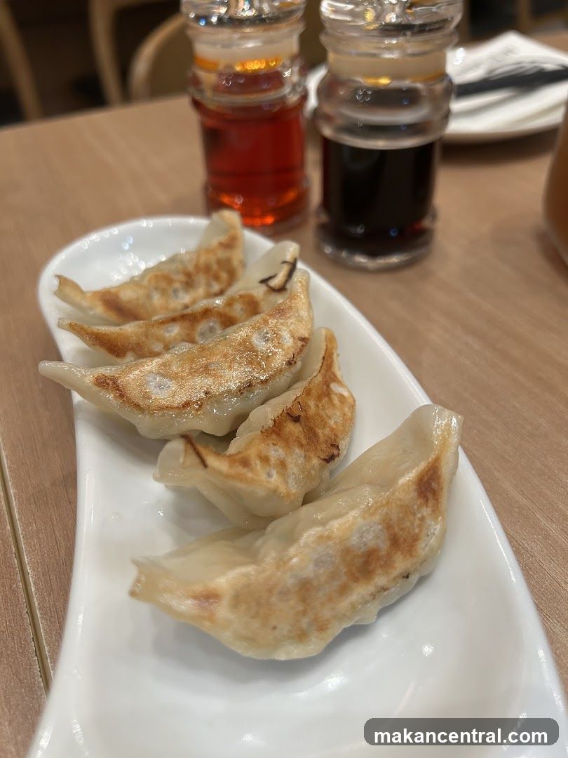 Gyoza on Plate with Condiments
