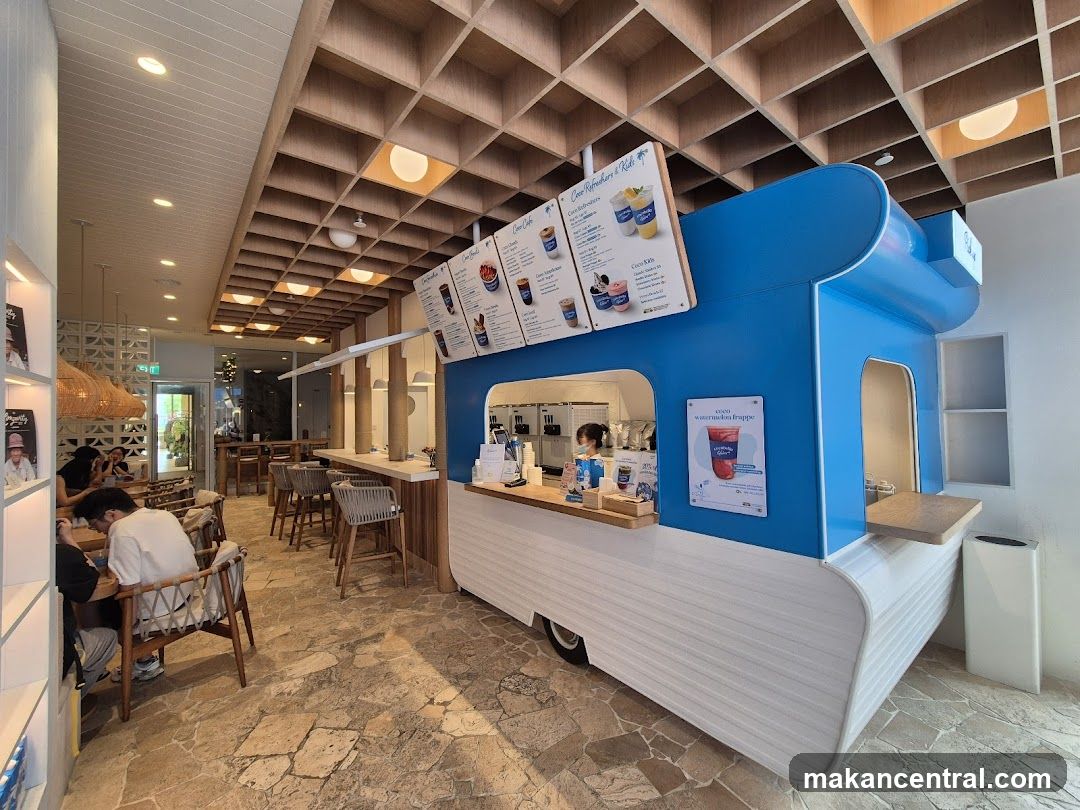 Interior of a café with a blue food cart