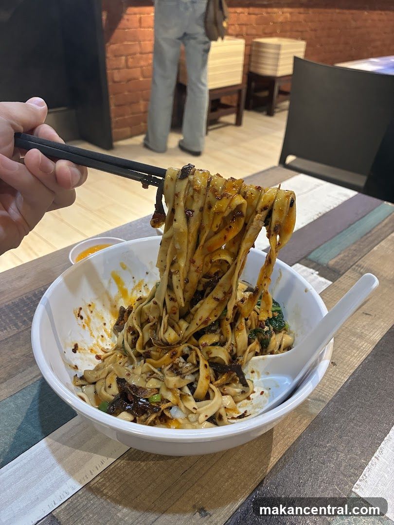 Noodles being lifted with chopsticks