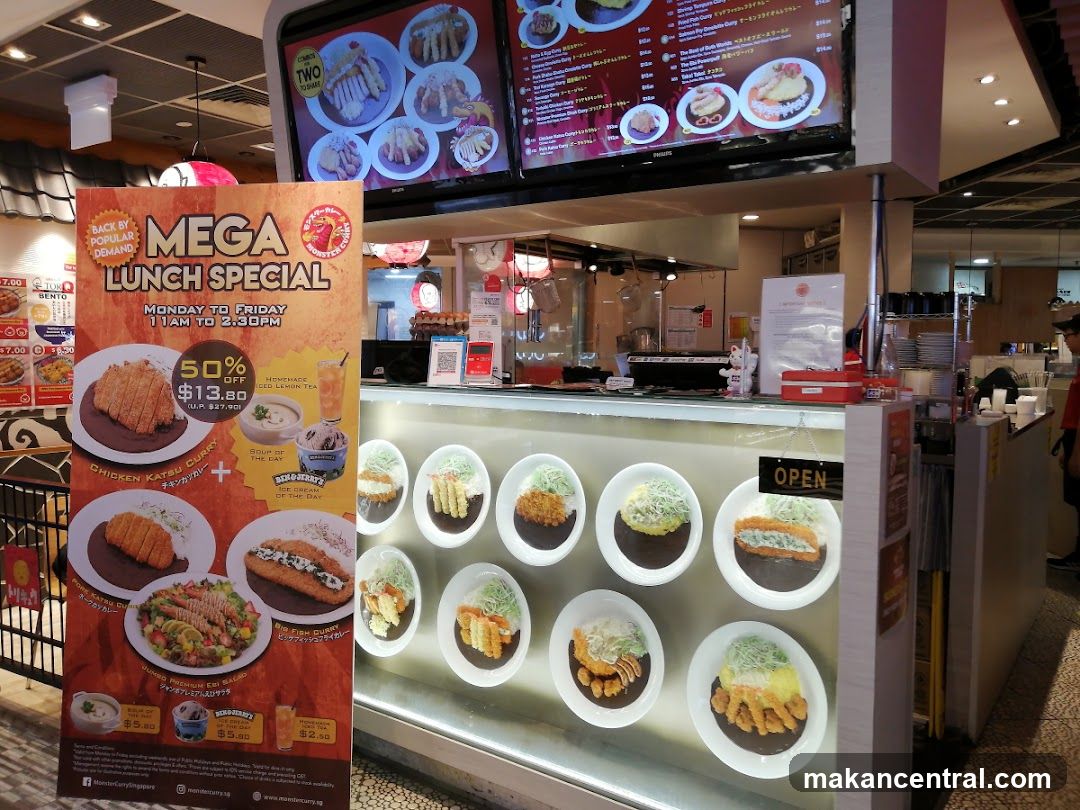 Restaurant interior with display counter and promotional poster