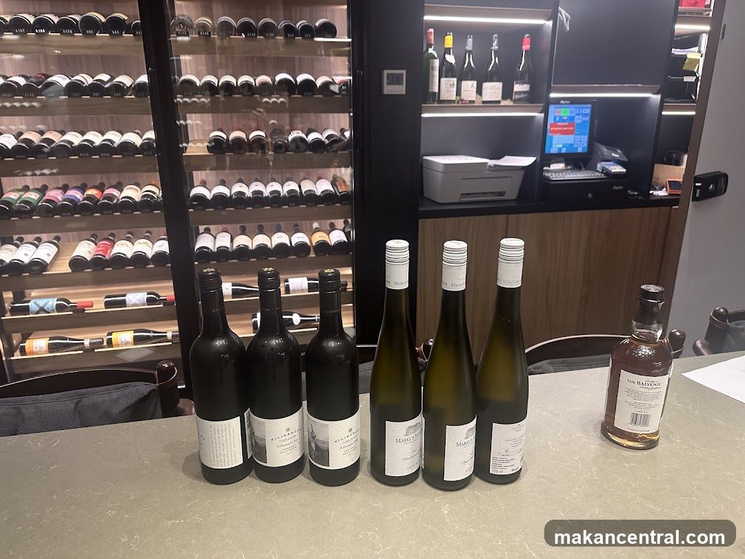 Wine bottles and a bottle of whiskey on a table