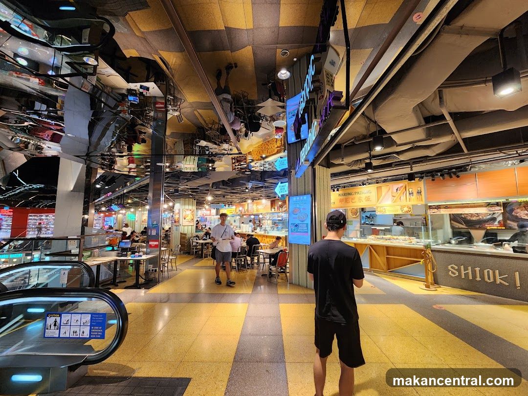 Food court with various stalls and seating areas