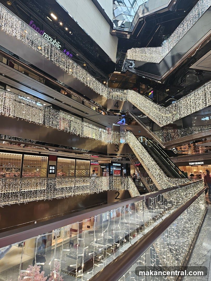 Interior of a shopping mall with escalators and lights