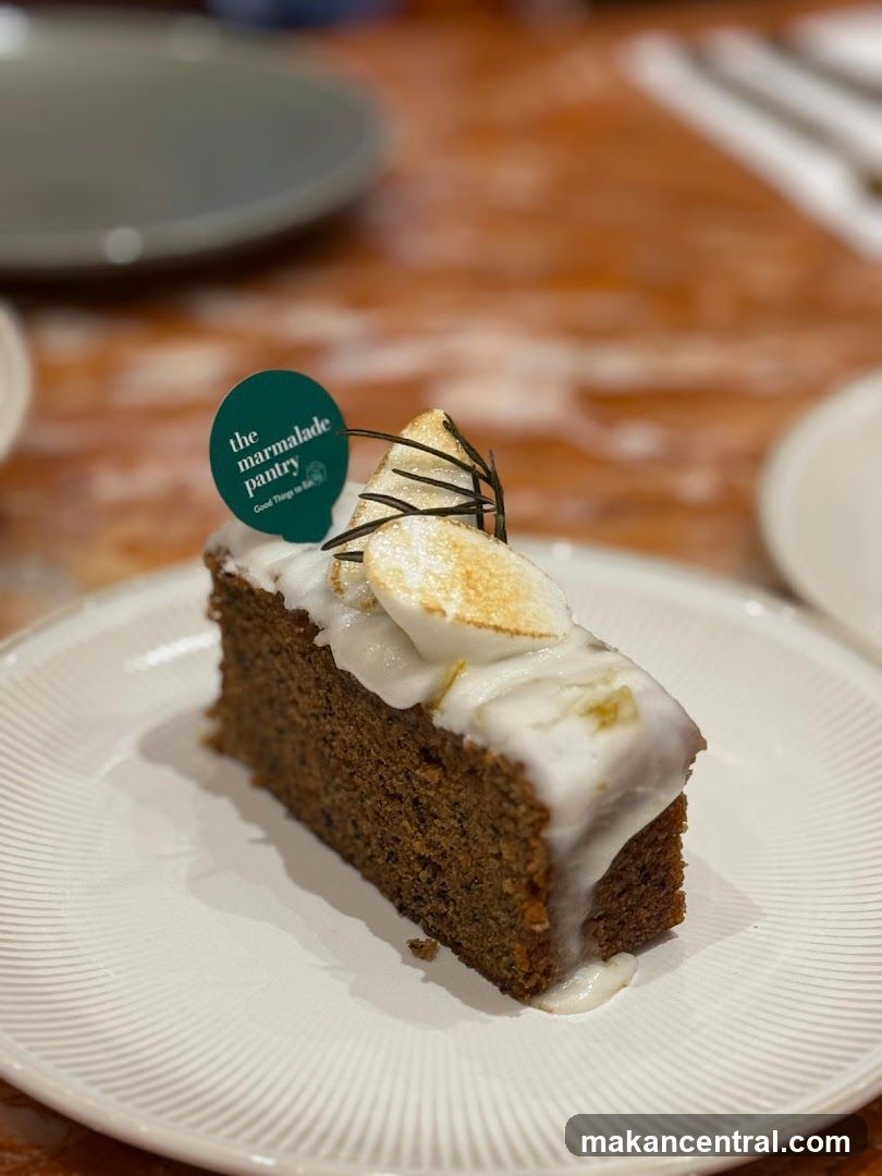 Slice of cake with meringue and rosemary garnish