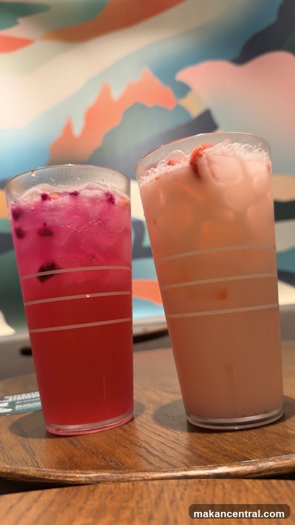 Two colorful drinks on a wooden tray
