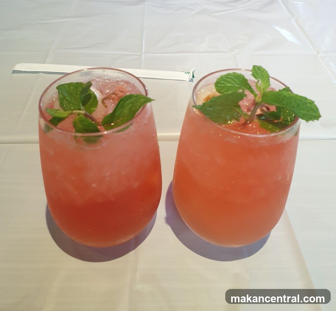 Two pink drinks with mint garnish