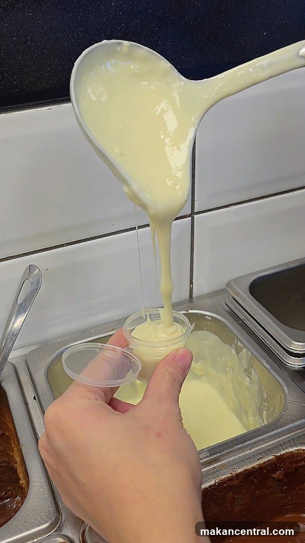 Sauce being dispensed into small containers