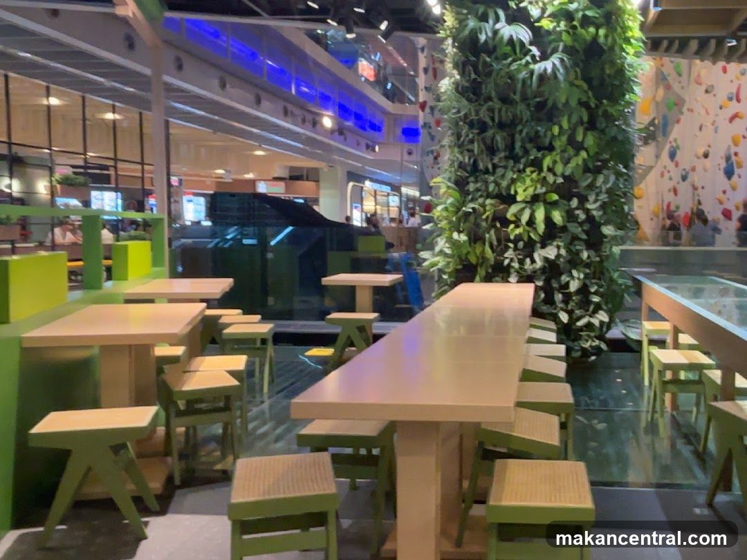 Indoor seating area with a vertical garden and climbing wall