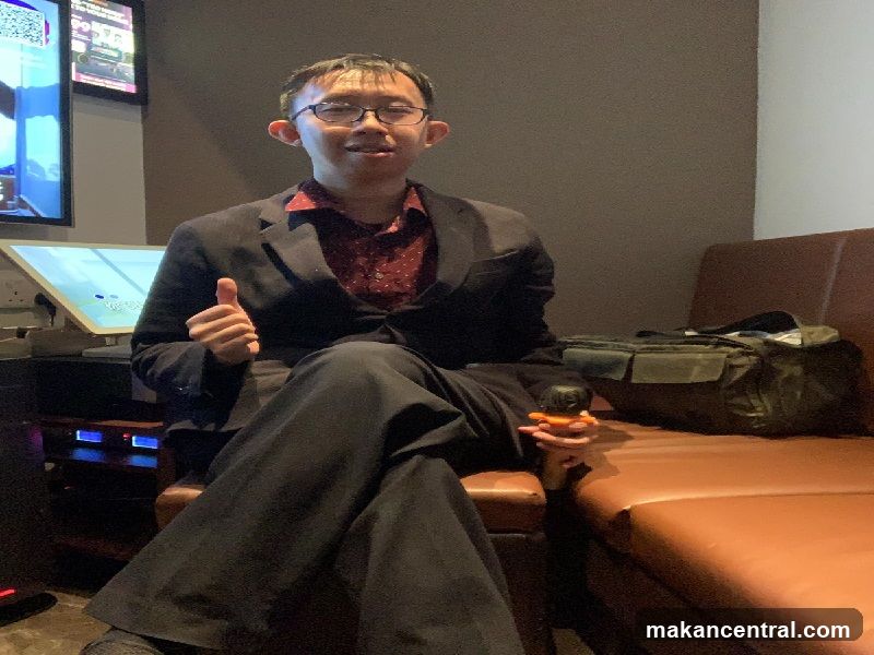 Man in a suit giving a thumbs up