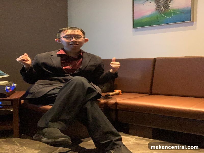 Man in a suit giving a thumbs up