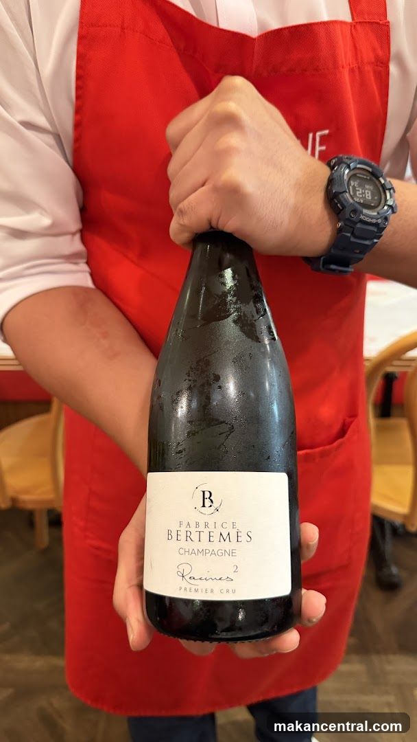 Champagne bottle held by server