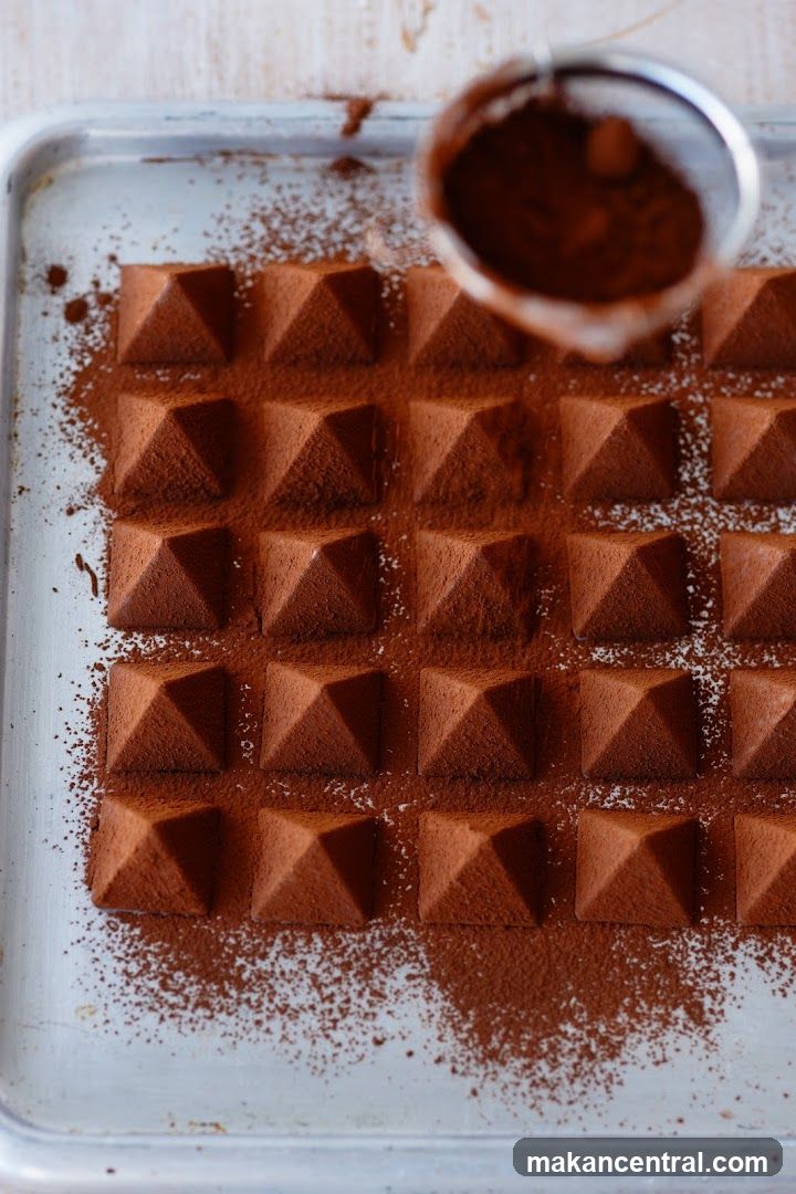 Chocolate Truffles Being Dusted with Cocoa Powder