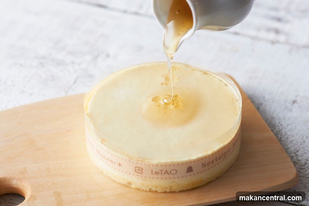 Syrup being poured onto a cake