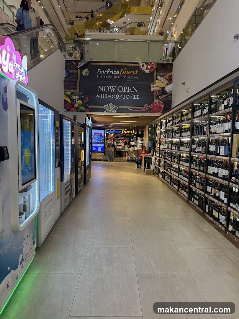 Supermarket aisle with frozen yogurt machines and wine shelves