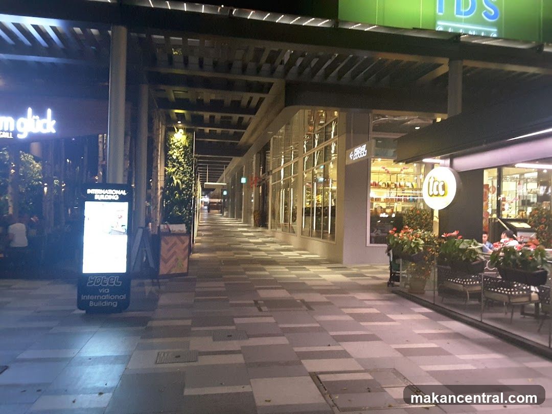 Outdoor walkway with shops and signage