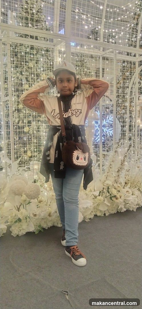 Girl Posing in Front of a Festive Display