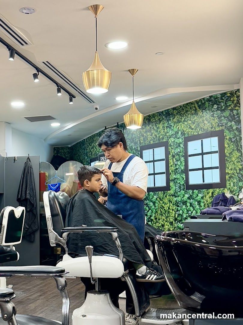 Barber cutting a boy's hair